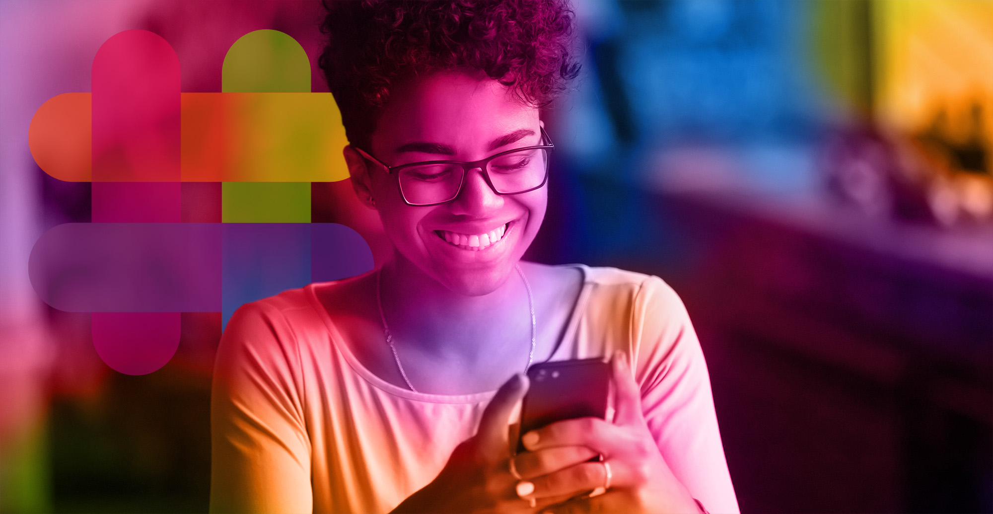 Happy millennial african american woman holding smartphone witht the "we are here" icon behind her.